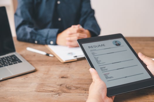 HR managers are interviewing job applicants who fill out their resume on the job application form in order to consider accepting a job as a company photo