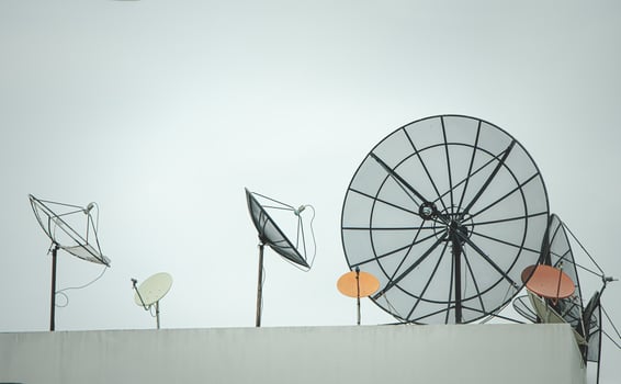 Many old communication satellite dishes expired and left on rooftops. photo
