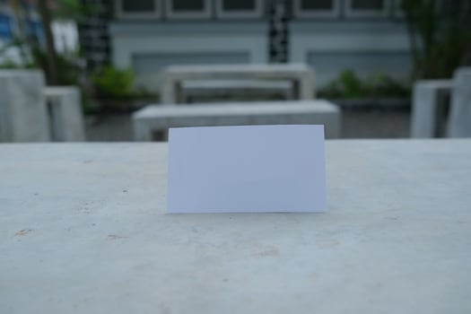 Blank white card on a concrete surface. photo