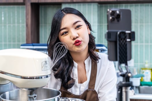 Young asian women is shop owner Put on an apron making cream for cupcakes, Using electric mixer, Preparing Cookies, Cooking, Homemade, Made specifically to sell photo