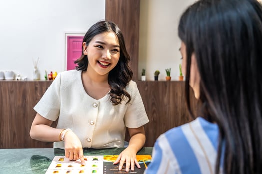 Young asian beautiful female customer select coffee or juice items. with a young woman barista working at the cafe or restaurants counter, entrepreneurial concept Starting a small business, lifestyle photo