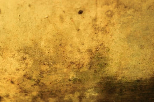 Abstract background with a textured, weathered, and golden surface. photo
