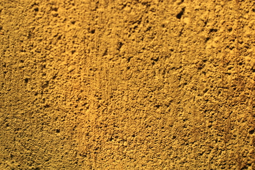 Close-up of a textured yellow wall. photo