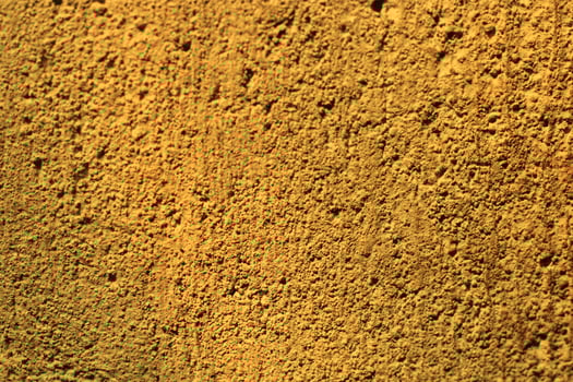 Close-up texture of a rough, golden wall. photo