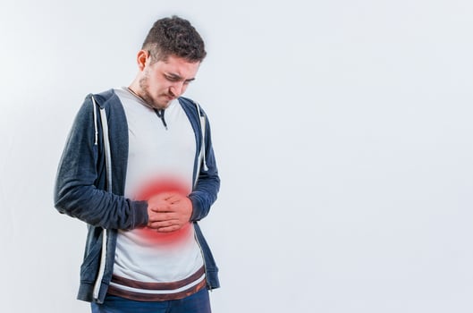 Unhappy man with digestive problems isolated. Person with digestive and stomach problems isolated photo