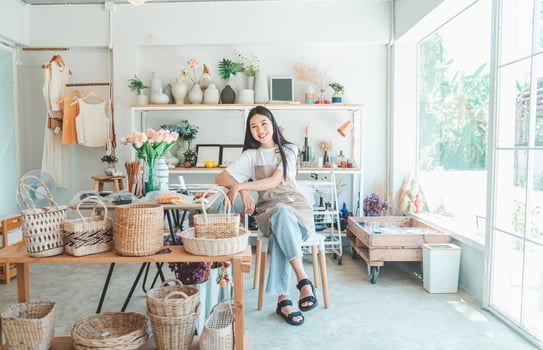 Small business owners pose smiling in their small shop to welcome customers and get customers online. And check the orders that customers have ordered of online retailers - online shopping. photo