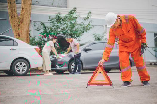 Insurance officers hold a red emergency triangle sign on the road to indicate that there is an accident or car breakdown on the road ahead. photo