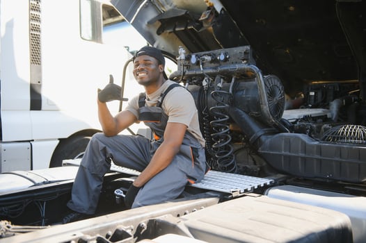 African american Professional Truck Mechanic Rebuilding Heavy Duty Truck Diesel Engine. Automotive Industry Theme photo
