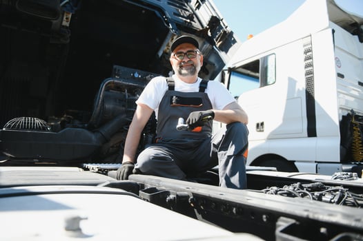 Mechanic repairing the truck in the garage photo