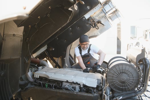A senior worker checks wheel. Truck malfunction. Service work photo