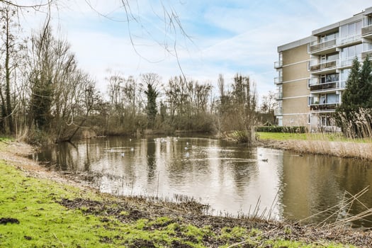 A small pond in front of a building photo