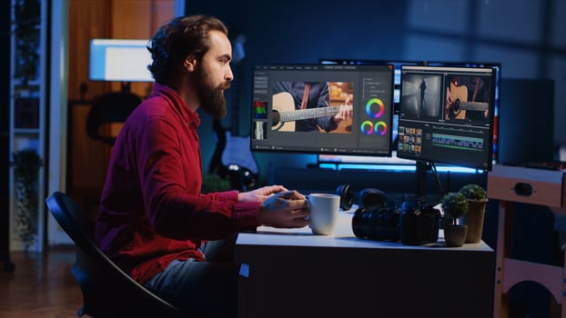 editor starting work on film montage, using specialized software applications on PC. Freelancer arriving in personal studio with cup of coffee, preparing to cut project footage photo