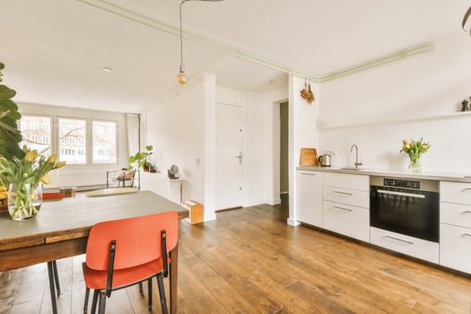 A kitchen with a table and chairs in it photo