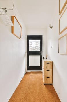 A hallway with a door and a cabinet photo