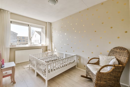 A baby's room with gold polka dot wallpaper photo