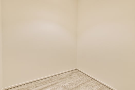 Empty room with white walls and wooden floor photo
