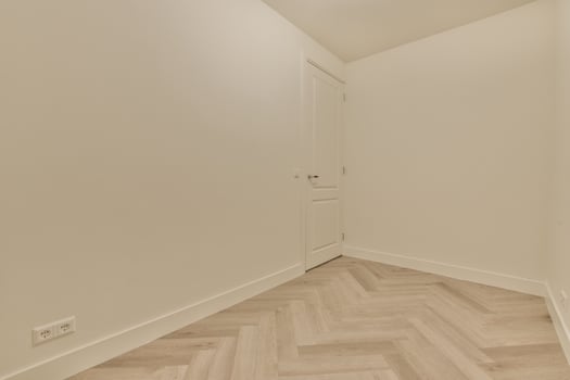 A room with white walls and wooden floors photo