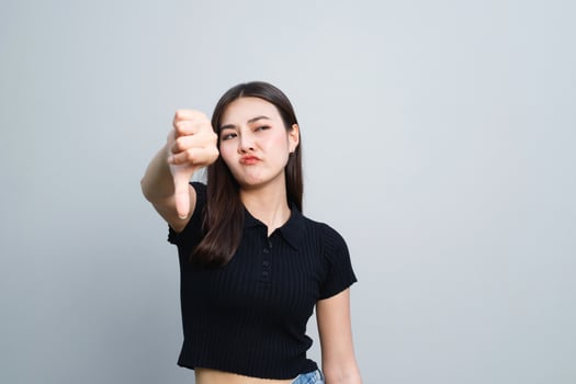 Model asian woman is emotional bad showing dissatisfaction, thumbs down photo