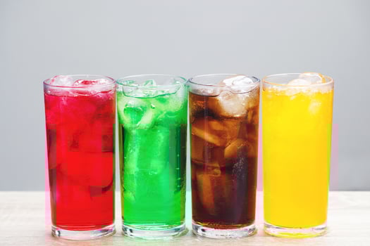 Soft drinks and fruit juice mixed with soda high in sugar have a negative effect on physical health photo