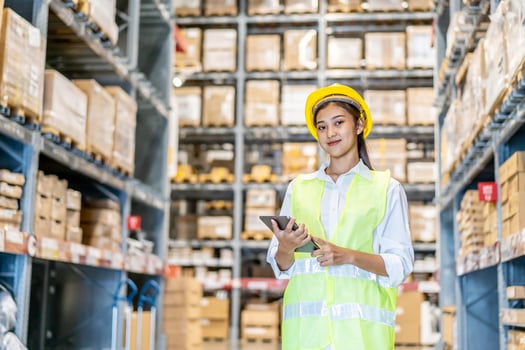 Portrait of asian woman warehouse worker in uniform checks stock and inventory with digital tablet computer, working in delivery, distribution center, logistic and business export photo