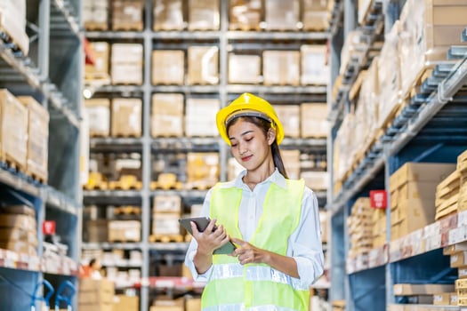 Portrait of asian woman warehouse worker in uniform checks stock and inventory with digital tablet computer, working in delivery, distribution center, logistic and business export photo