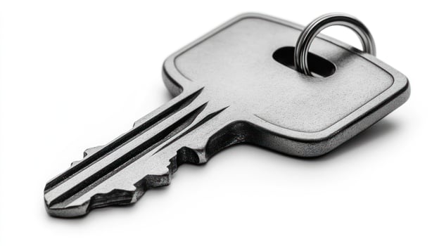 A solitary key lies on a pristine surface, evoking thoughts of security and belonging photo