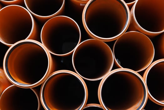 brown plastic plumbing pipes with rubber seals photo
