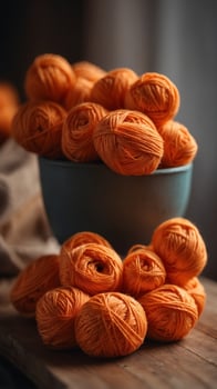 A bunch of orange yarn is piled on a table. photo