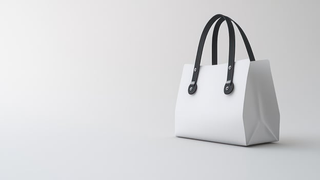 A stylish white handbag with black handles stands elegantly on a smooth surface photo