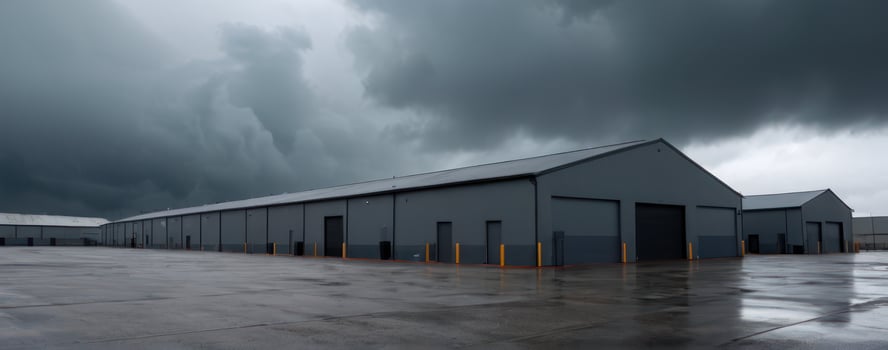 A grey building with dark clouds in the sky photo