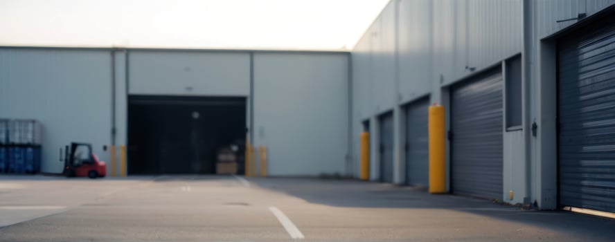 An empty warehouse with a forklift in the background photo