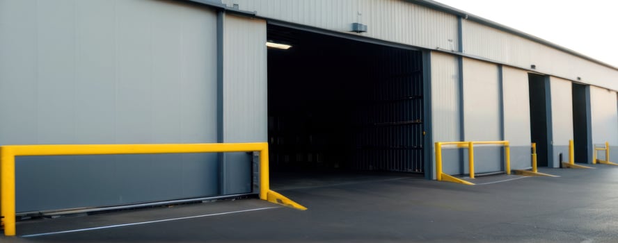 The entrance to a warehouse with yellow barriers photo