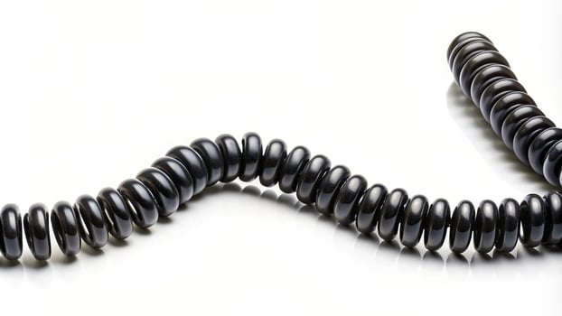 communication, twist, medium shot, telecommunication, technology,Black, swirl, connectivity, cord, isolated, A medium shot of a black spiral telephone cord isolated on a white background photo