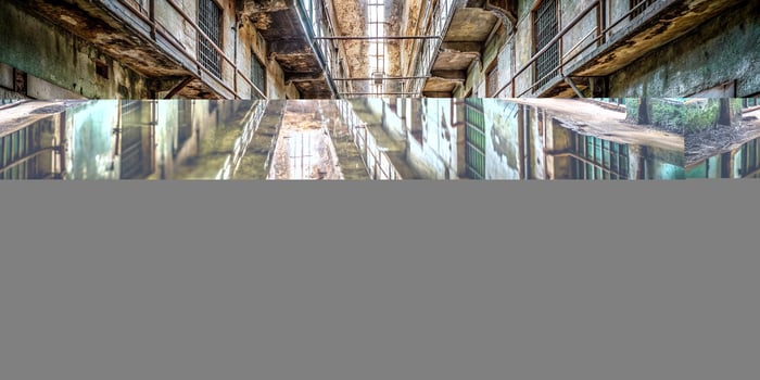 decaying, crumbling, dark, old, decaying walls, water reflection, haunted, grimy, spooky, gloomy, neglected, desolate, Abandoned prison hallway with water reflection and detailed decay photo