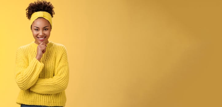 Enthusiastic creative good-looking black young woman wearing sweater headband excellent plan smiling satisfied thrilled look thoughtful camera make up idea, standing yellow background photo