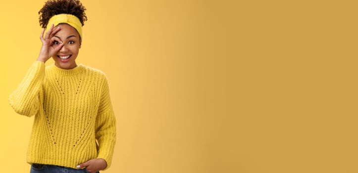 Charming tender feminine african-american girlfriend show circle on eye ok okay gesture look lucky happily smiling satisfied impressed waiting excitement travel friends, yellow background photo