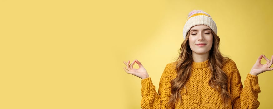 Keep calm carry on. Portrait relieved happy meditating charming young woman learn control feelings breething yoga practice smiling delighted relaxed close eyes hands sideways zen nirvana gesture photo