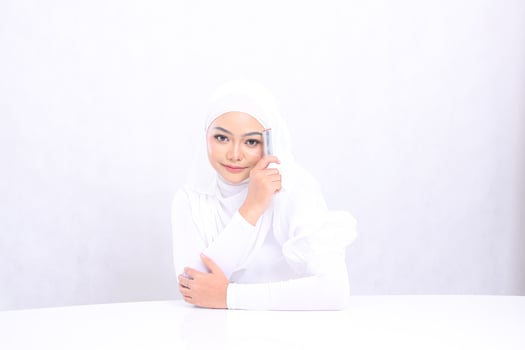 closeup makeup lips Beautiful young girl asia hijab smile look at camera hand hold lipstick on left face isolated white background. cosmetic advertising concept, lip color, lipstick mock up photo