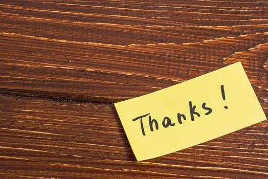 yellow sticky note with the word thanks written on it. photo