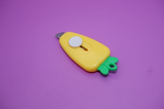 cute mini cutter with carrot shape. cute cutter isolated on purple background. photo