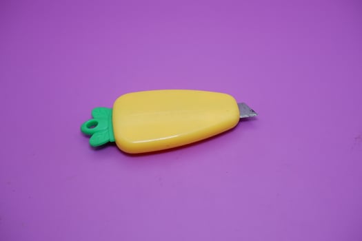 cute mini cutter with carrot shape. cute cutter isolated on purple background. photo