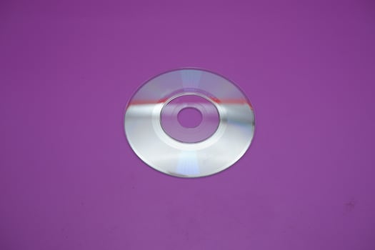a compact disc isolated on purple background photo