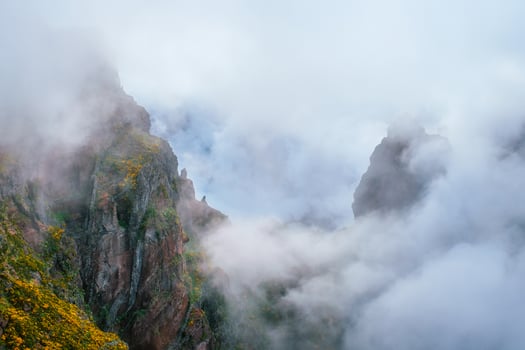 A mountain covered in fog and clouds. Madeira island, Portugal photo