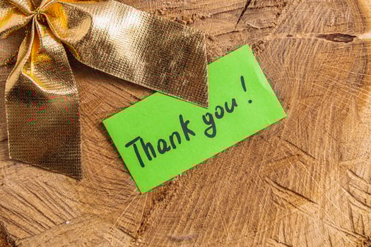 A word of thanks to a small green leaf on a piece of wood photo