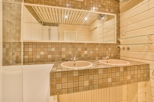 A bathroom with two sinks and a mirror photo