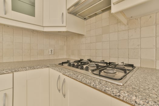 A kitchen with a stove and a sink photo