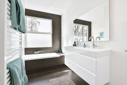 A modern bathroom with a white sink and tub photo