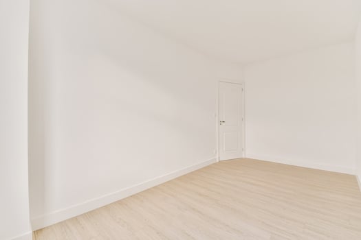 Empty room with white walls and wooden floors photo