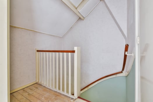 A stairway with a railing and a door photo