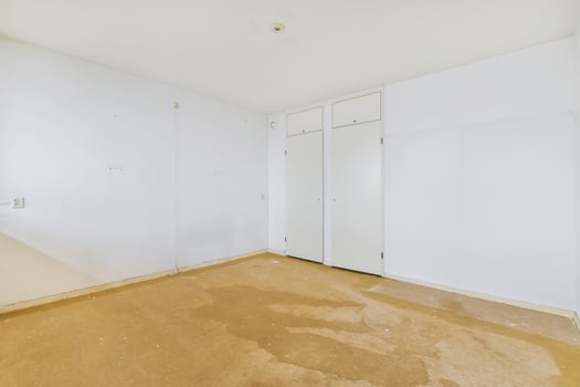 Empty room with white walls and brown floor photo
